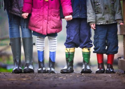 four children standing on dirt during daytime