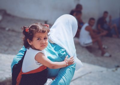 girl on back of woman wearing blue long-sleeved top